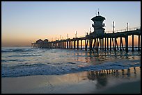 Huntington Pier reflected in wet sand at sunset. Huntington Beach, Orange County, California, USA ( color)
