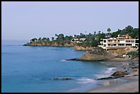 Rocky coastline with waterfront houses at dawn. Laguna Beach, Orange County, California, USA