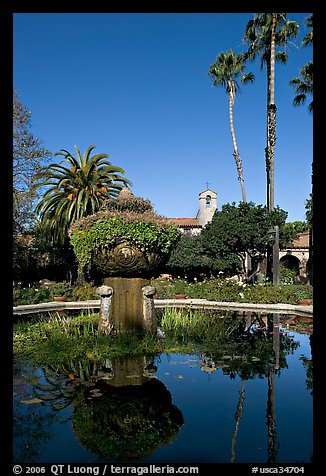 Palm trees reflected in central  courtyard basin. San Juan Capistrano, Orange County, California, USA