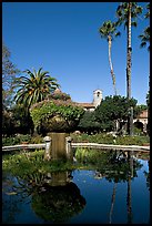 Palm trees reflected in central  courtyard basin. San Juan Capistrano, Orange County, California, USA