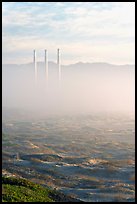 Chimneys of power plant emerging from the fog. Morro Bay, USA (color)