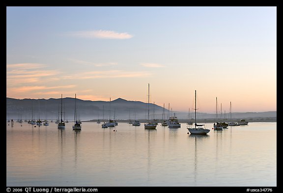 Yachts in calm Morro Bay harbor, sunset. Morro Bay, USA