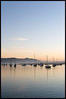 Yachts reflected in Morro Bay harbor, sunset. Morro Bay, USA