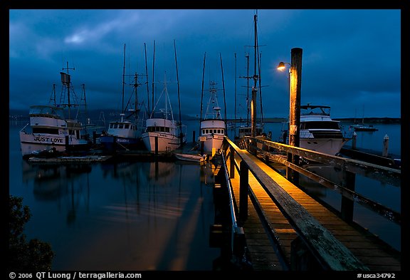 Deck and boats at night. Morro Bay, USA