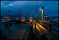 Deck and boats at night. Morro Bay, USA