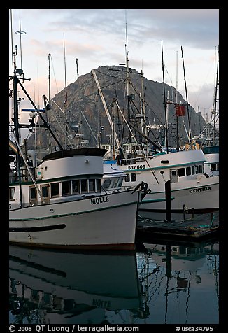Fishing boats and Morro Rock, sunrise. Morro Bay, USA