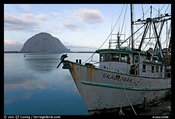 Baat with rusted hull and Morro Rock. Morro Bay, USA