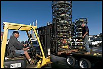 Men loading crab traps onto a truck. Morro Bay, USA