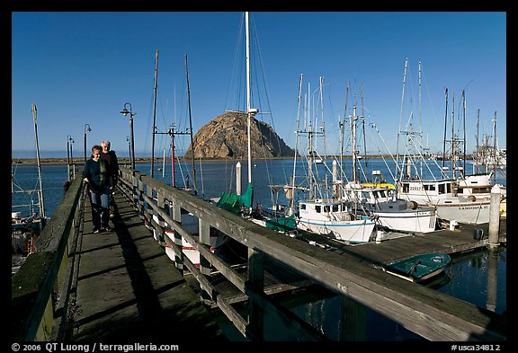 People walking on a deck in the harbor. Morro Bay, USA (color)