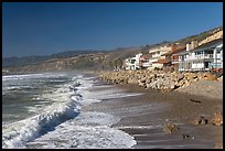 Surf and beachfront houses near Rincon Island. California, USA (color)