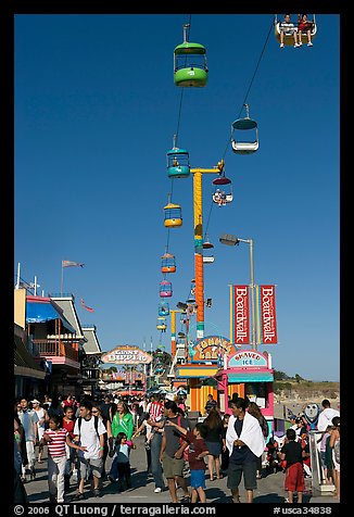 Crowd on the beach boardwalk on a summer afternoon. Santa Cruz, California, USA