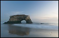 Sea arch and reflection, Natural Bridges State Park, dusk. Santa Cruz, California, USA ( color)