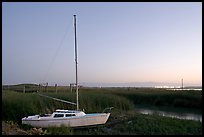 Yacht and marsh at dusk, Alviso. San Jose, California, USA