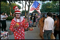 Woman in clown costume waiving American Flag, Independence Day. San Jose, California, USA