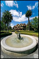 Wide view of fountain and mansion. Winchester Mystery House, San Jose, California, USA (color)