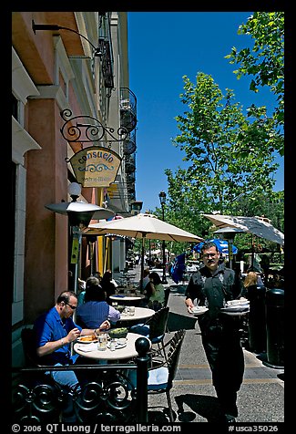 Streetside restaurant terrace and waiter. Santana Row, San Jose, California, USA