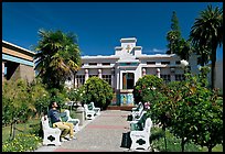 Visitor sitting on a bench, Rosicrucian Park. San Jose, California, USA (color)