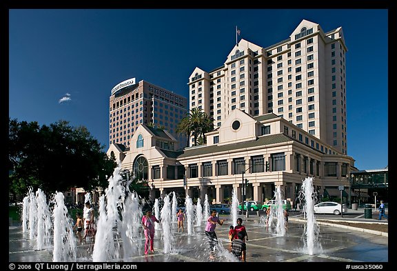 Children playing in fountain on Plaza de Cesar Chavez. San Jose, California, USA (color)