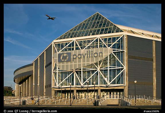 HP Pavilion with person and plane, late afternoon. San Jose, California, USA