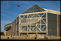 HP Pavilion with person and plane, late afternoon. San Jose, California, USA