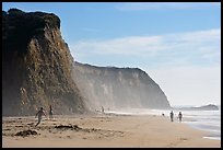 People strolling and playing below cliffs, Scott Creek Beach. California, USA (color)