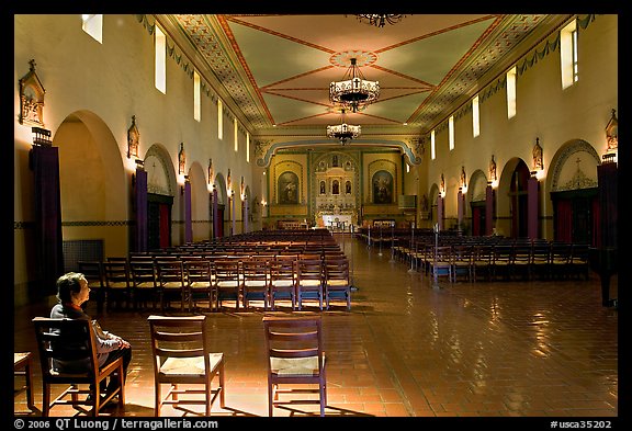 Woman sitting in chapel, Mission Santa Clara de Asis. Santa Clara,  California, USA (color)