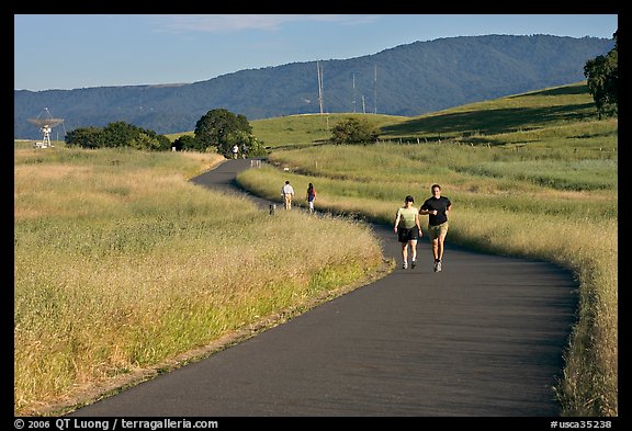 People jogging on trail in the foothills. Stanford University, California, USA
