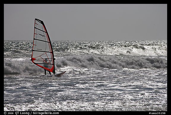 Windsurfer on silvery ocean, Waddell Creek Beach. California, USA