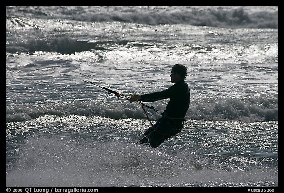 Kitesurfer silhouette against silvery water, Waddell Creek Beach. California, USA (color)