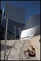 Women sunning on the steps of the entrance of the Walt Disney Concert Hall. Los Angeles, California, USA