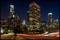 Bridge, traffic lights and Los Angeles skyline at night. Los Angeles, California, USA