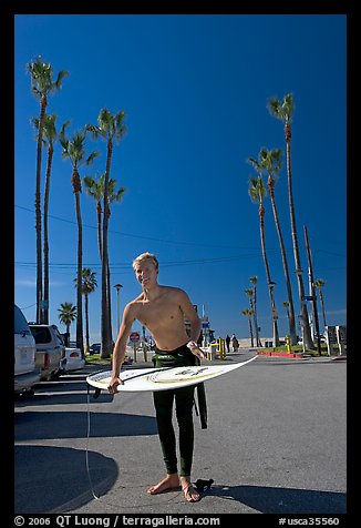 Surfer and palm trees. Venice, Los Angeles, California, USA