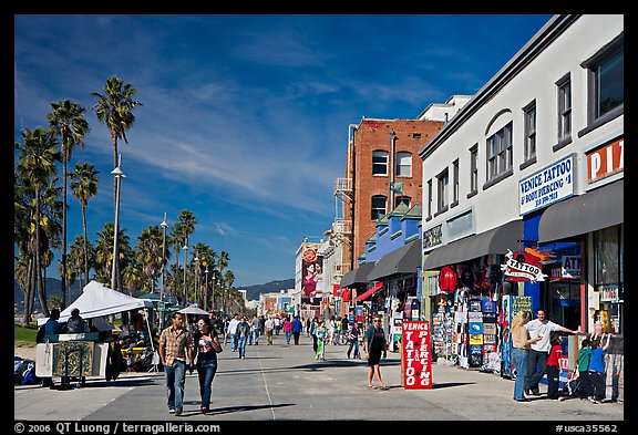 Couple strolling on Venice Boardwalk. Venice, Los Angeles, California, USA (color)