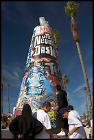 Young men decorating a cone on the beach. Venice, Los Angeles, California, USA ( color)