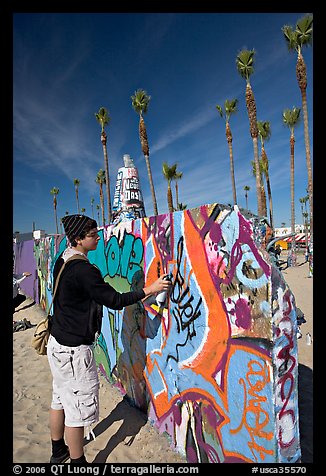 Young man making graffiti on a wall. Venice, Los Angeles, California, USA (color)