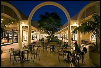 Sitting at outdoor table at night, Stanford Shopping Center. Stanford University, California, USA ( color)