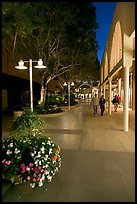 Couple walking by stores and flowers, Stanford Shopping Center. Stanford University, California, USA (color)