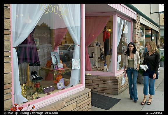 Women walking by storefront on Main Street. Half Moon Bay, California, USA