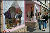 Women walking by storefront on Main Street. Half Moon Bay, California, USA