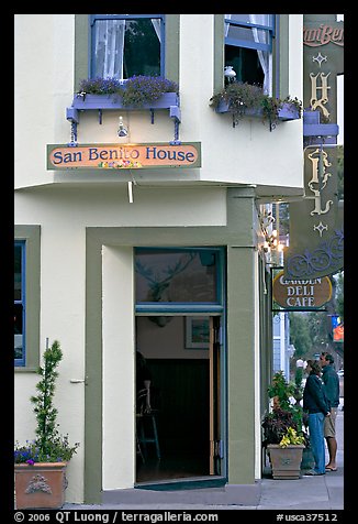 Entrance of historic San Benito House, with couple looking. Half Moon Bay, California, USA