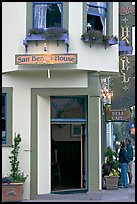 Entrance of historic San Benito House, with couple looking. Half Moon Bay, California, USA (color)