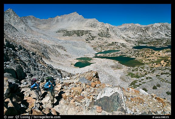 Backpackers hiking up from Saddlebag Lakes, John Muir Wilderness. California, USA (color)