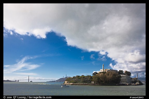 Golden Gate Bridge and Alcatraz under large cloud. San Francisco, California, USA (color)