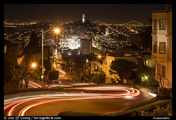 Sharp switchbacks on Russian Hill with Telegraph Hill in the background, night. San Francisco, California, USA (color)