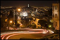 Sharp switchbacks on Russian Hill with Telegraph Hill in the background, night. San Francisco, California, USA