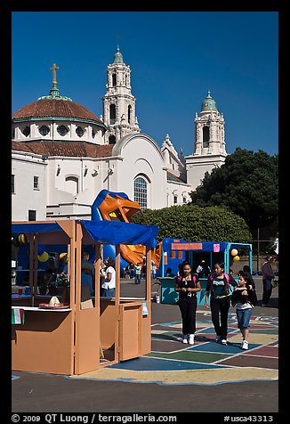 School fair booth, children, and Mission Dolores in the background. San Francisco, California, USA (color)