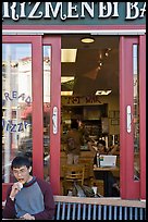 Man biting pizza outside pizzaria, Haight-Ashbury district. San Francisco, California, USA (color)