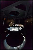 Tourists look at moving image of ocean inside the Camera Obscura, Cliff House. San Francisco, California, USA (color)