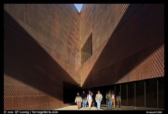 Tourists walking out of a striking corner of De Young Museum. San Francisco, California, USA (color)