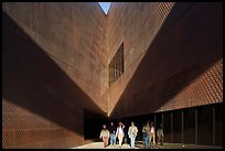 Tourists walking out of a striking corner of De Young Museum. San Francisco, California, USA (color)